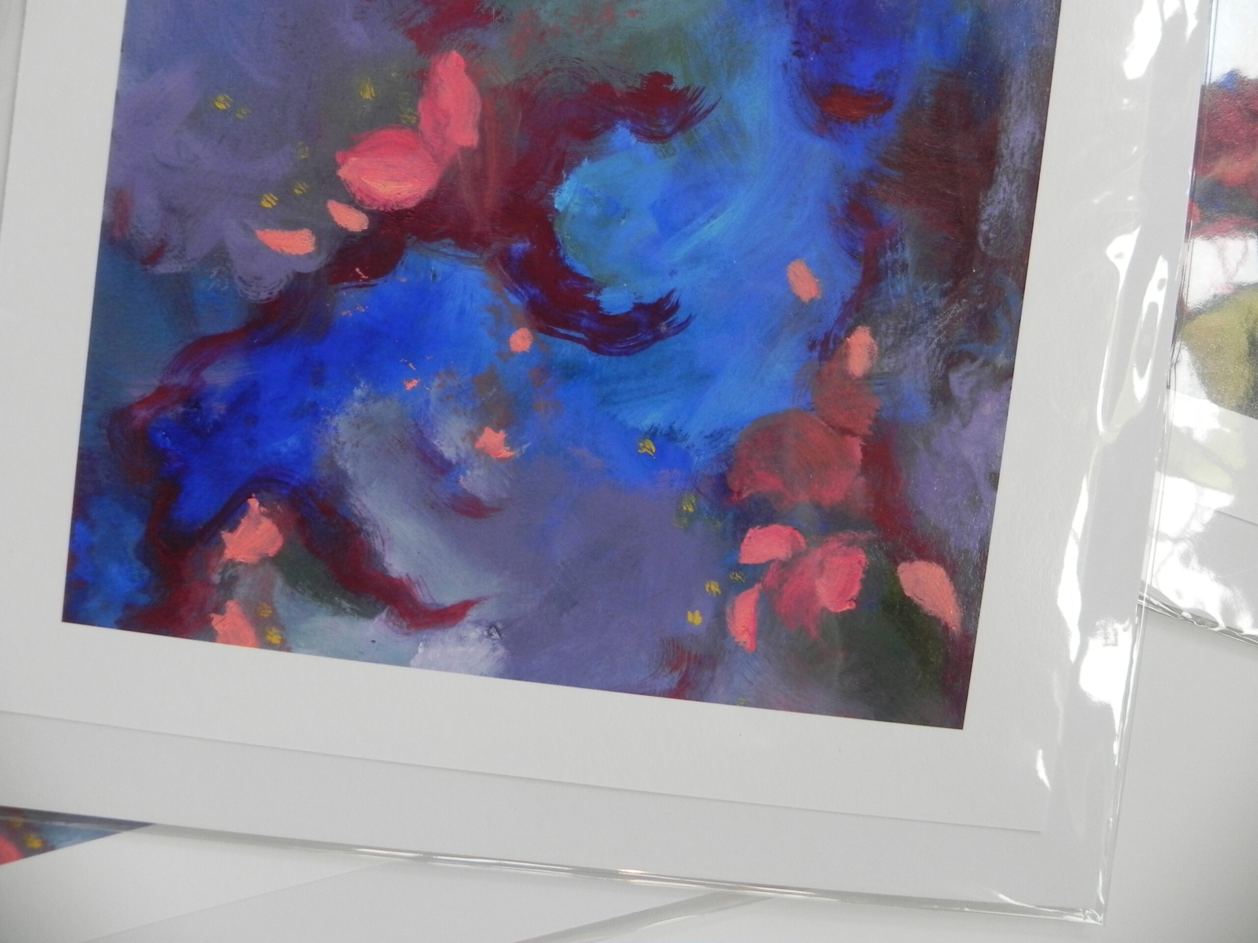 Abstract art print with blue, red, and purple hues in white matting