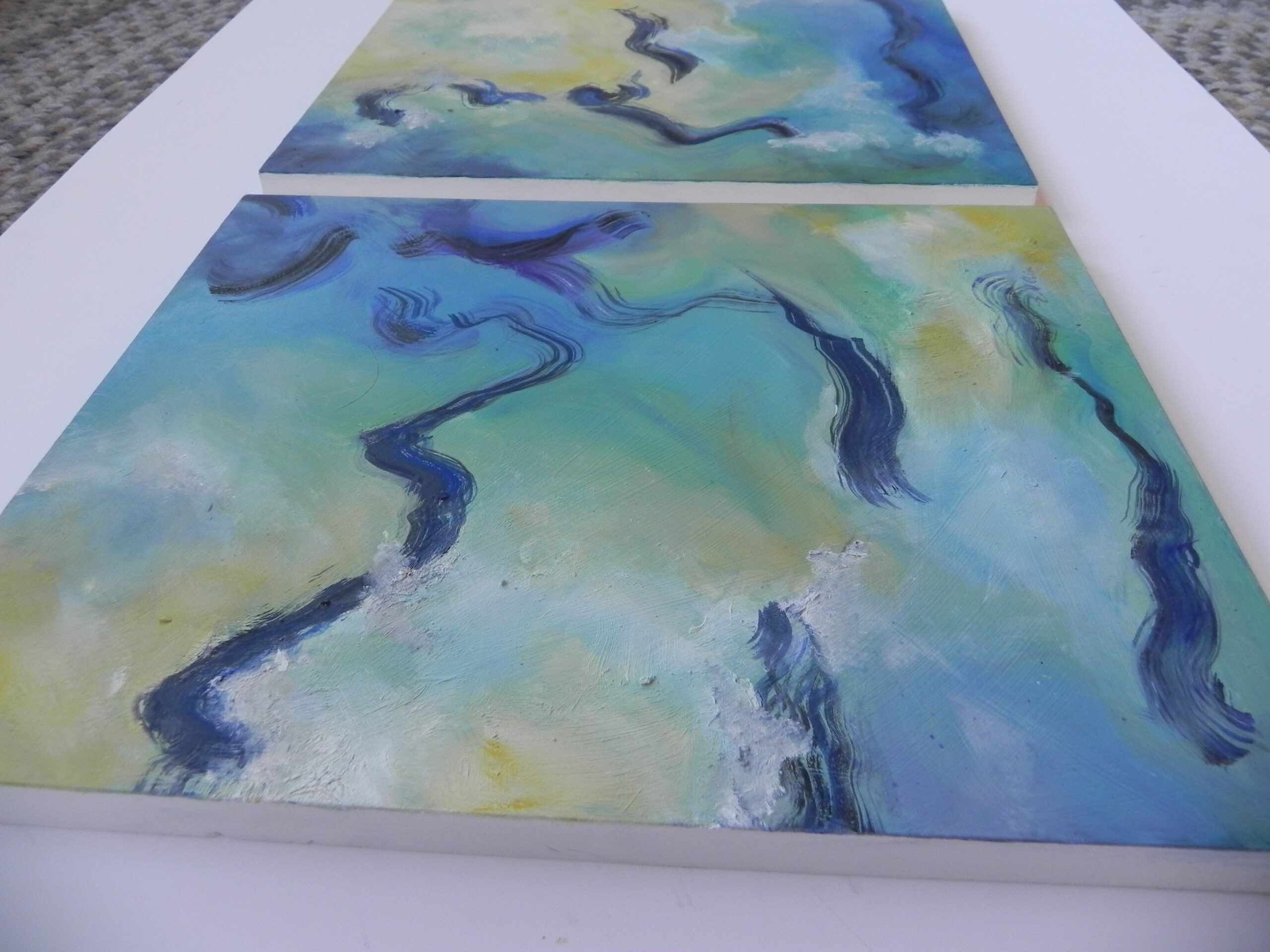 Abstract artwork featuring wavy blue lines across teal and yellow sections, displayed as two horizontal panels in a white frame.