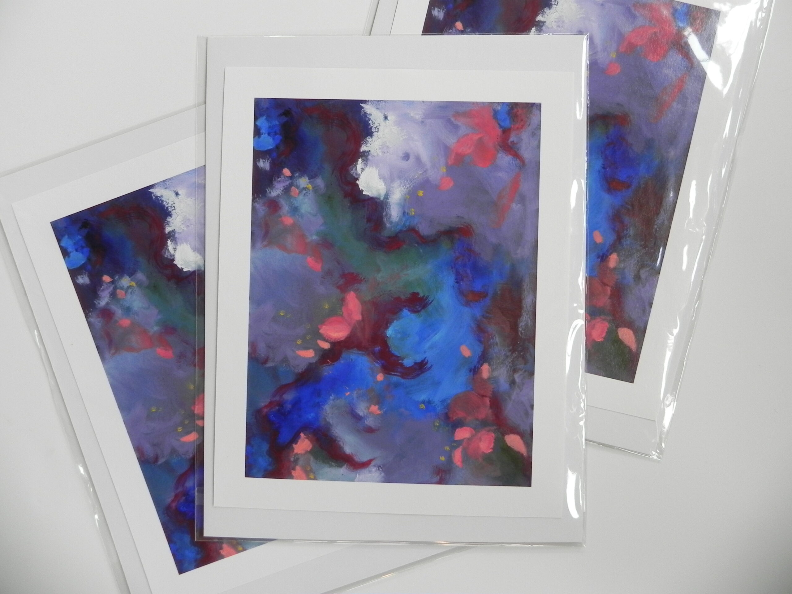 Abstract art print with blue, red, and purple hues on white mat in clear sleeve