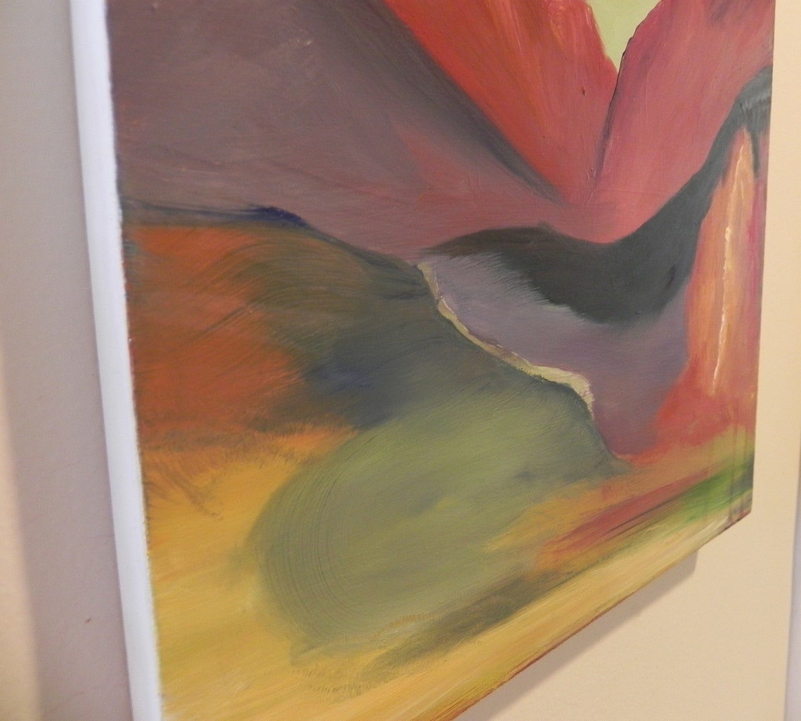 Abstract oil painting with red, green, and yellow brushstrokes on canvas