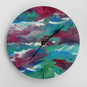 Round wall clock with abstract painted face in teal, magenta, and white with black hands