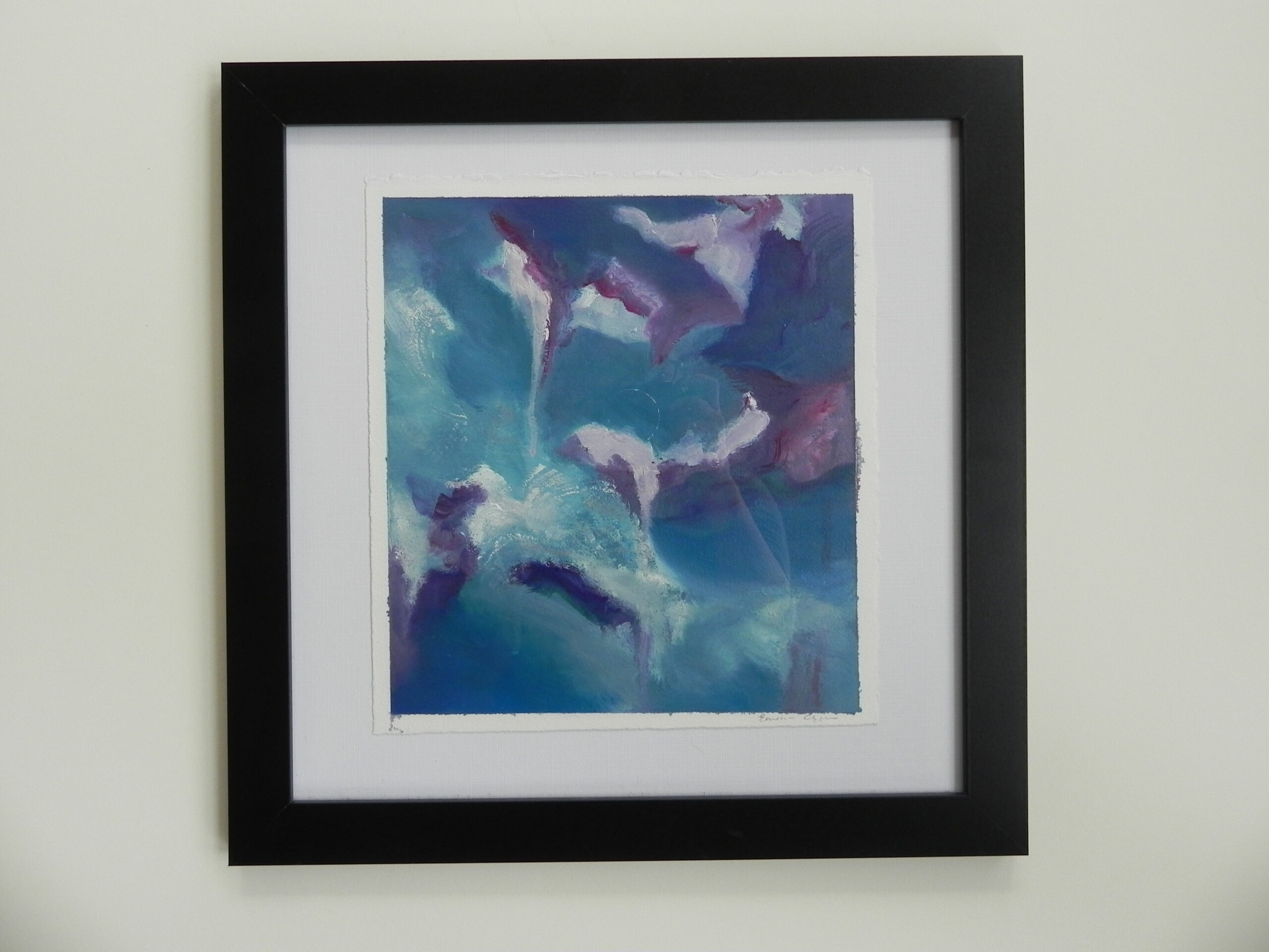 Framed abstract painting showing dark blue and purple shapes against a teal background, displayed in a black frame with white matting.
