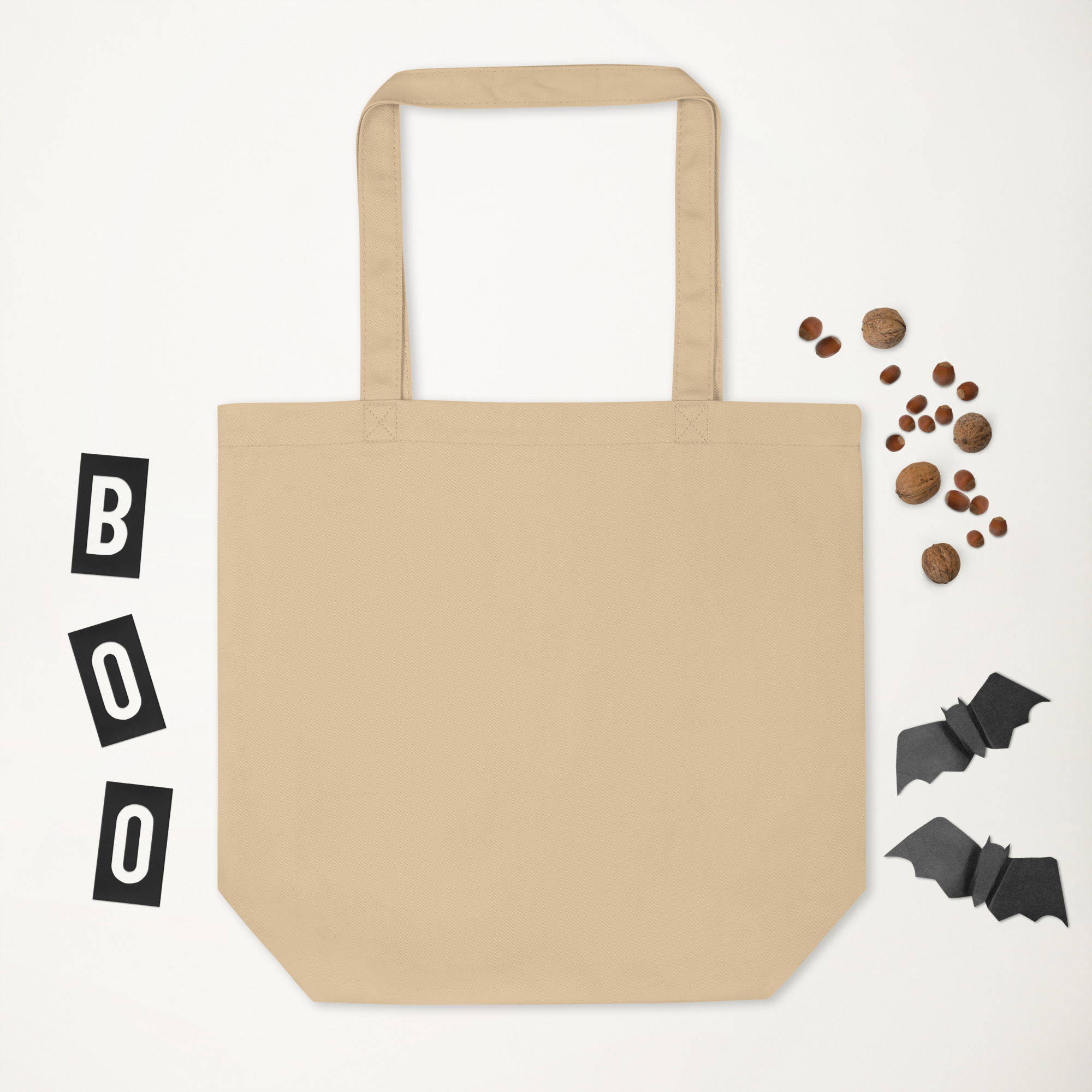 Plain beige canvas tote bag with long handles on white background