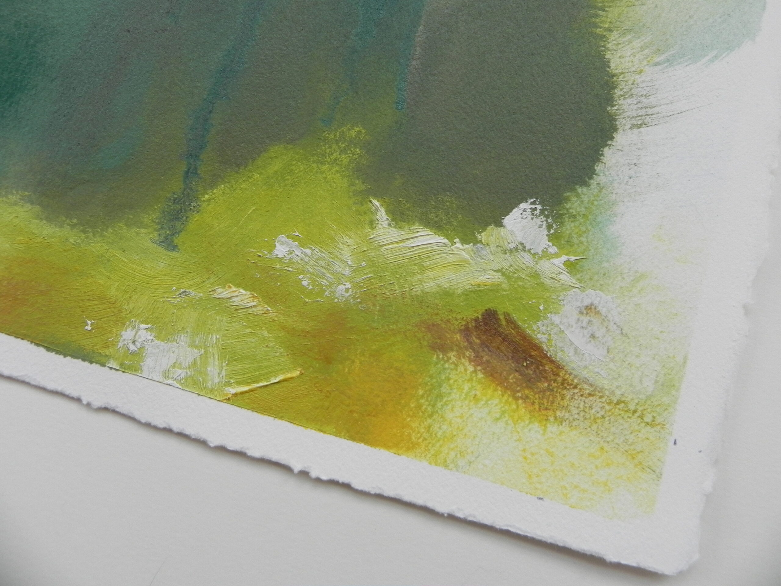 Abstract watercolor painting with green and yellow brushstrokes on textured paper