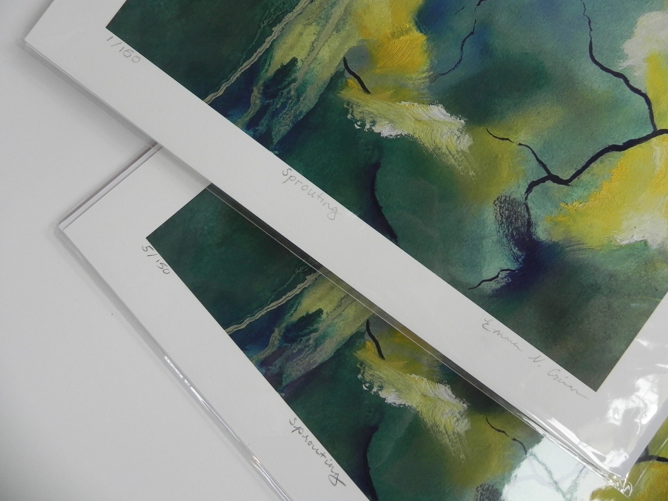 Two limited edition art prints titled Sprouting featuring abstract green and yellow landscapes with black branch details