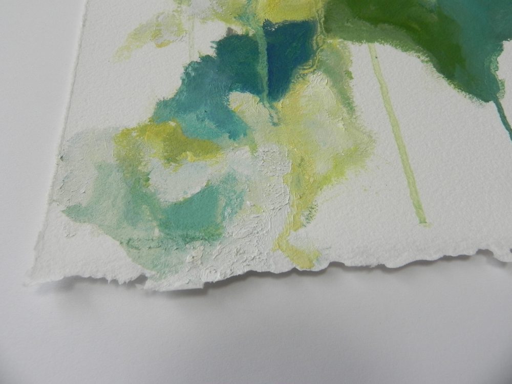 Abstract watercolor painting with green and yellow hues on textured paper