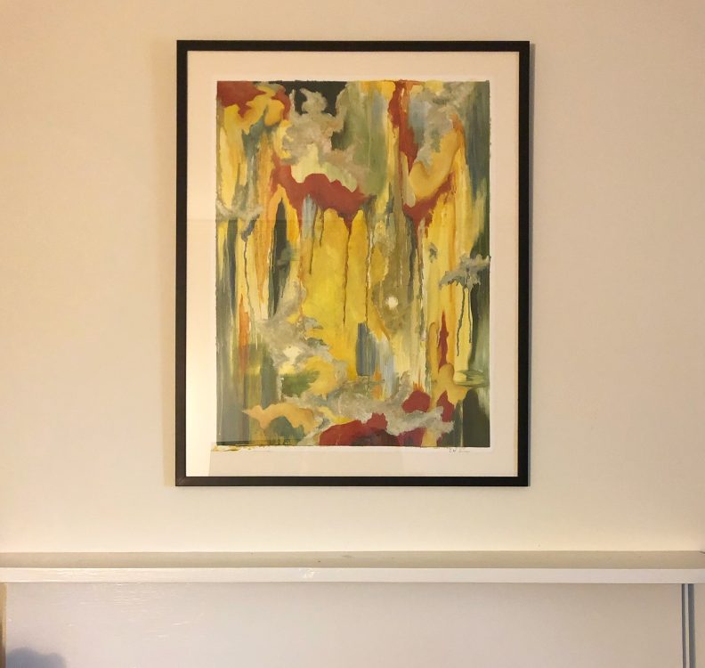 Framed abstract art print with yellow, red, and green vertical brushstrokes in black frame